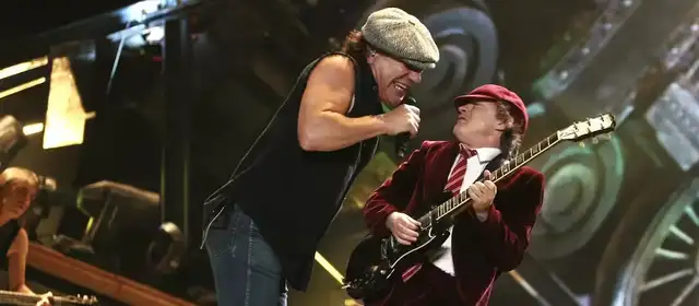 Brian Johnson e Angus Young do AC/DC, uma das bandas que mudaram de vocalista, no palco em um show ao vivo